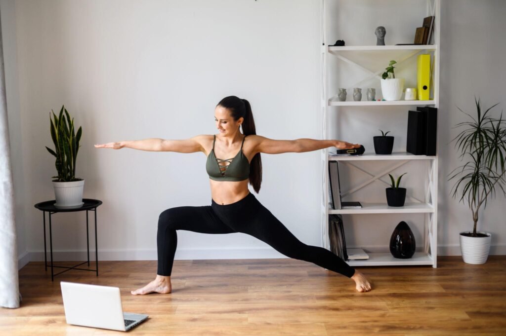 beginner doing meditation yoga at home with laptop online class